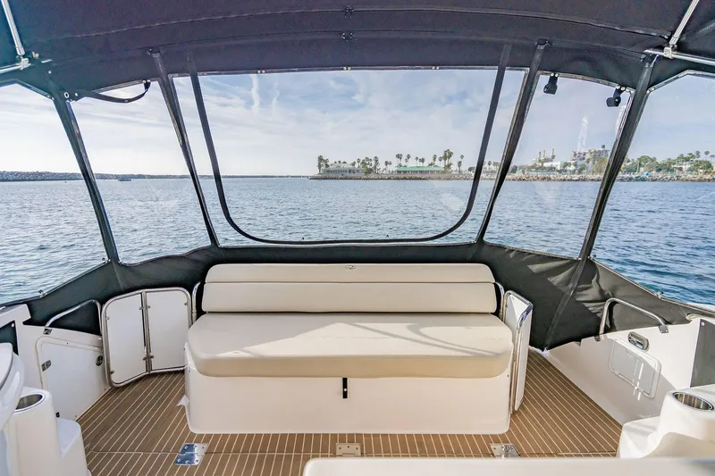 Slide: The Image of 2010 Regal Commodore 4460 boat interior with ocean view and seating area. - 15