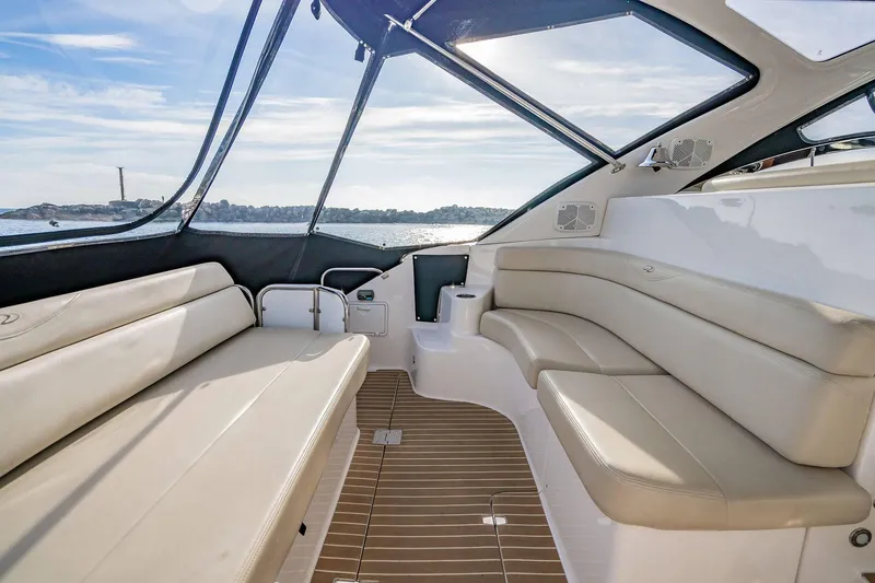 Slide: The Image of Luxurious interior of 2010 Regal Commodore 4460 yacht with beige seating and panoramic windows. - 16