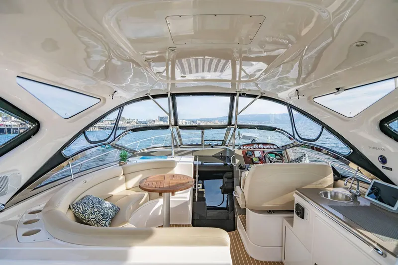 Slide: The Image of Luxurious interior of 2010 Regal Commodore 4460 yacht with panoramic windows and elegant seating. - 17
