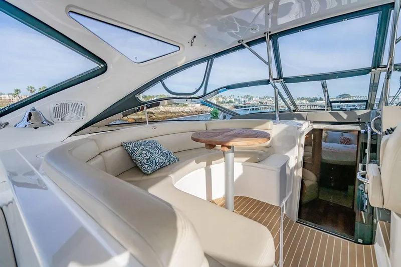 Slide: The Image of Luxurious interior of 2010 Regal Commodore 4460 yacht with plush seating and wooden table. - 19