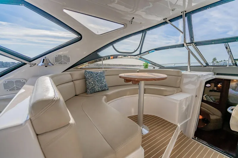 Slide: The Image of Luxurious interior of 2010 Regal Commodore 4460 yacht with plush seating and wooden table. - 21