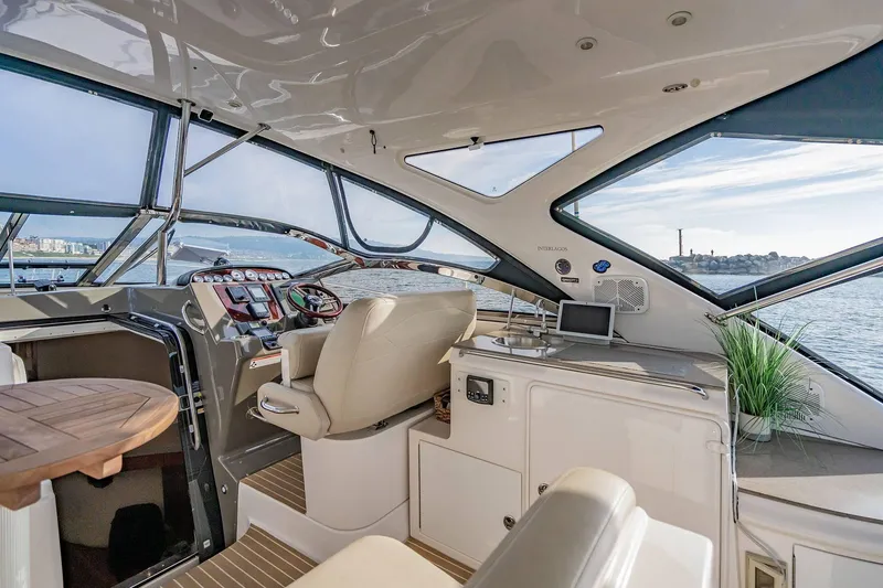 Slide: The Image of Luxurious interior of 2010 Regal Commodore 4460 yacht with helm and seating area. - 23