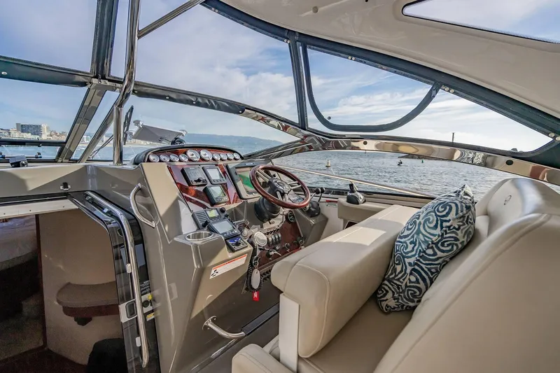 Slide: The Image of Interior view of 2010 Regal Commodore 4460 yacht cockpit with luxurious seating and controls. - 26