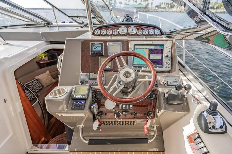Slide: The Image of Cockpit of 2010 Regal Commodore 4460 yacht with navigation instruments and steering wheel. - 27