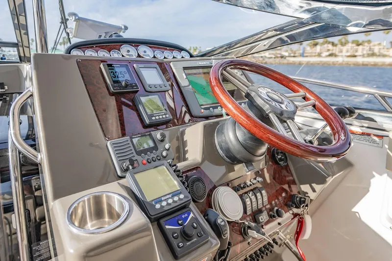 Slide: The Image of Control panel of 2010 Regal Commodore 4460 yacht with wooden steering wheel and navigation instruments. - 28