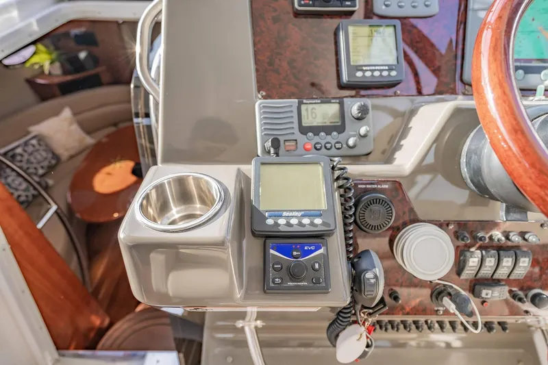 Slide: The Image of 2010 Regal Commodore 4460 yacht dashboard with navigation equipment and controls. - 29