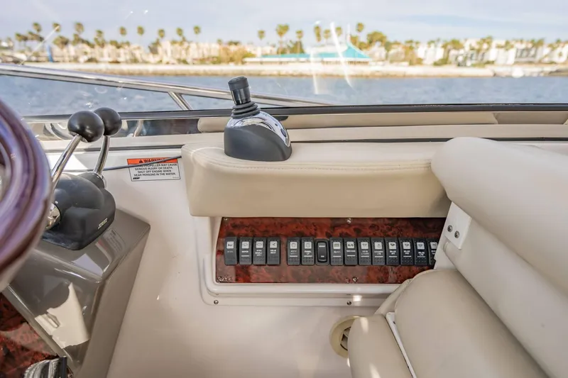 Slide: The Image of Interior view of a 2010 Regal Commodore 4460 yacht dashboard with control switches. - 33