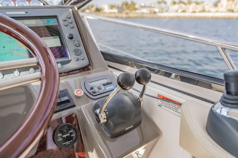 Slide: The Image of Control panel of 2010 Regal Commodore 4460 yacht with steering wheel and navigation system. - 35