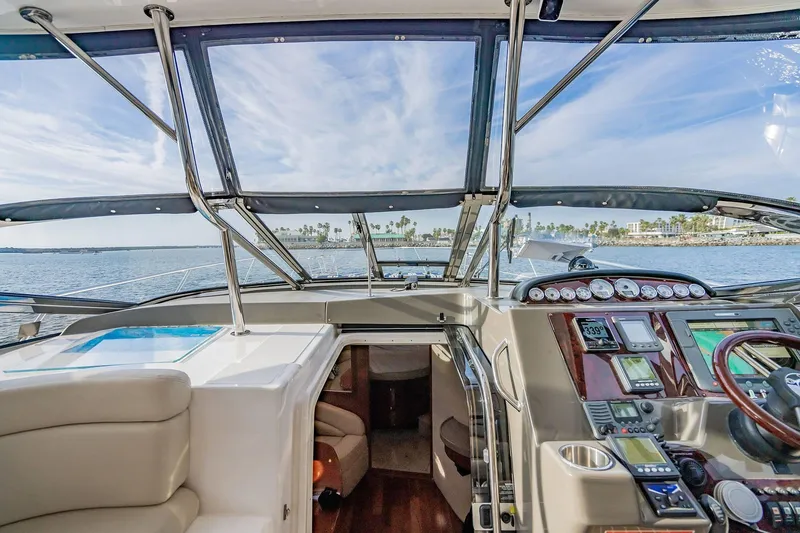 Slide: The Image of Interior view of 2010 Regal Commodore 4460 yacht cockpit with ocean backdrop. - 36