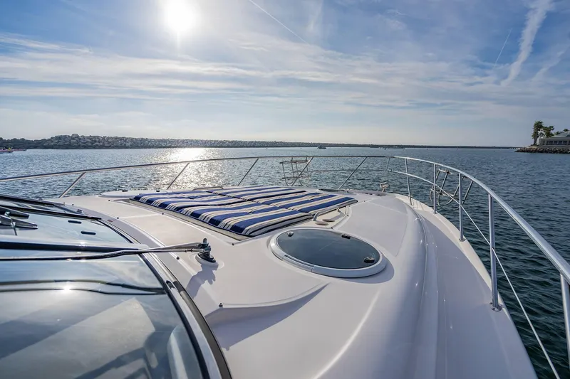Slide: The Image of 2010 Regal Commodore 4460 yacht on calm water under sunny sky. - 38