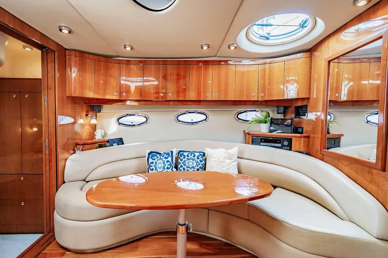 Slide: The Image of Luxurious interior of 2010 Regal Commodore 4460 yacht with elegant wood finish and plush seating. - 44