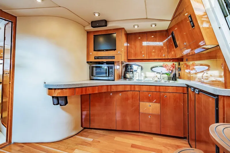Slide: The Image of Luxurious 2010 Regal Commodore 4460 yacht kitchen with modern appliances and elegant wood cabinetry. - 45