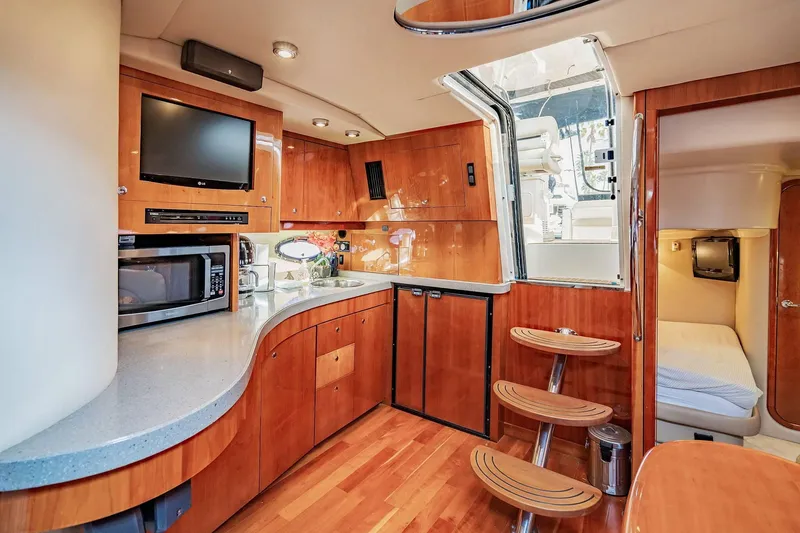 Slide: The Image of Luxurious interior of 2010 Regal Commodore 4460 yacht with modern kitchen amenities. - 48