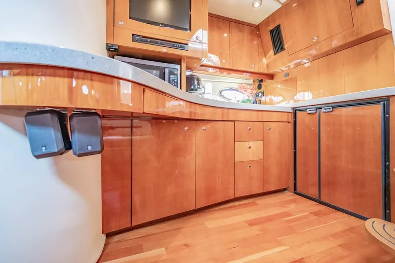 Slide: The Image of Luxurious interior of 2010 Regal Commodore 4460 yacht with wooden cabinetry and modern appliances. - 50