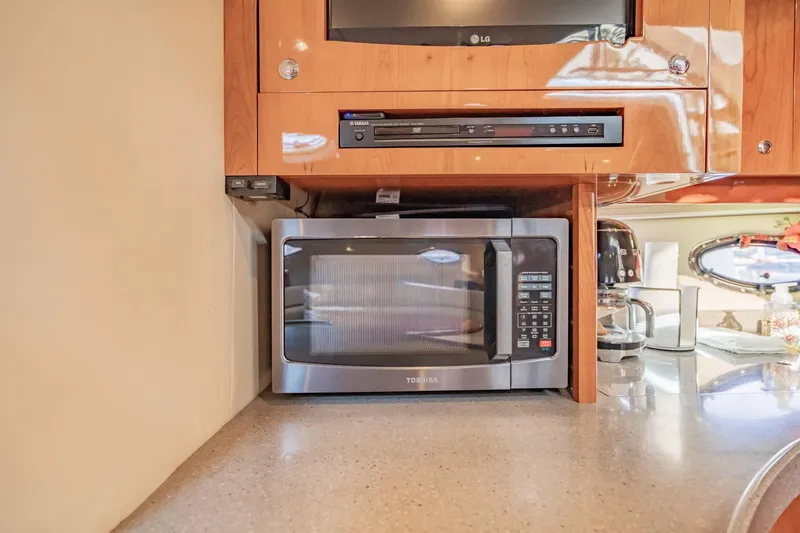 Slide: The Image of Microwave and appliances in 2010 Regal Commodore 4460 yacht kitchen area. - 51
