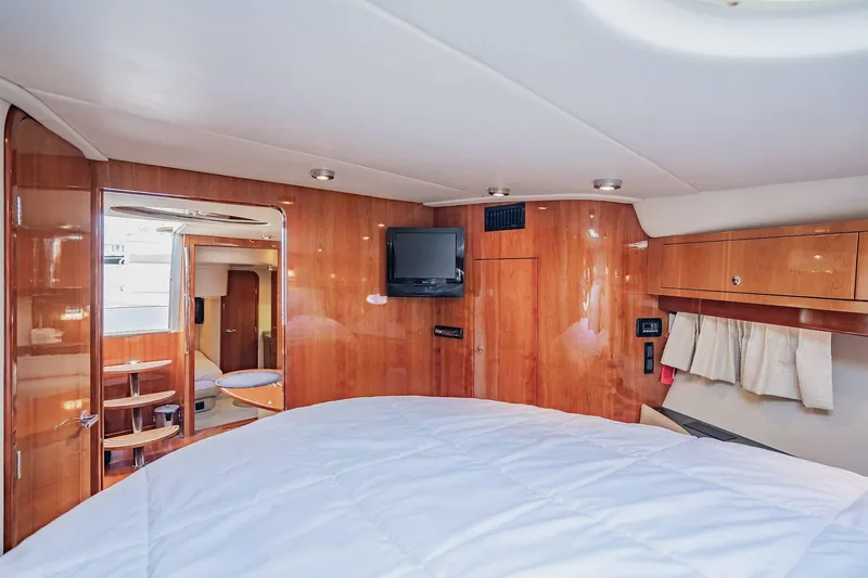 Slide: The Image of Luxurious cabin interior of 2010 Regal Commodore 4460 yacht with wood paneling and TV. - 55