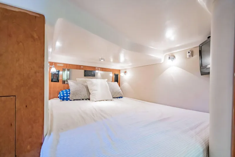 Slide: The Image of Cozy cabin interior of 2010 Regal Commodore 4460 yacht with bed and TV. - 60