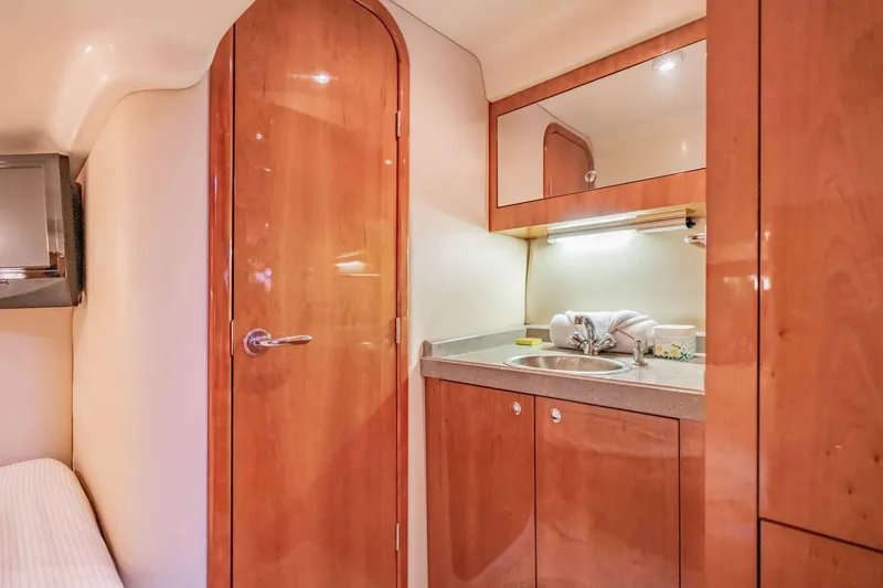 Slide: The Image of Luxurious 2010 Regal Commodore 4460 yacht interior with wooden cabinetry and compact sink area. - 61