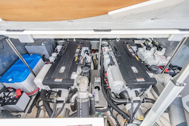 Slide: The Image of Engine compartment of a 2010 Regal Commodore 4460 boat, featuring dual engines and batteries. - 64