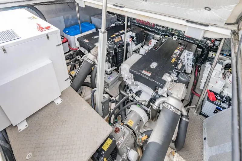 Slide: The Image of Engine room of 2010 Regal Commodore 4460 yacht, showcasing dual engines and equipment. - 66