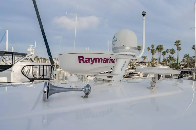 Slide: The Image of Radar equipment on 2010 Regal Commodore 4460 yacht, docked with palm trees in background. - 68