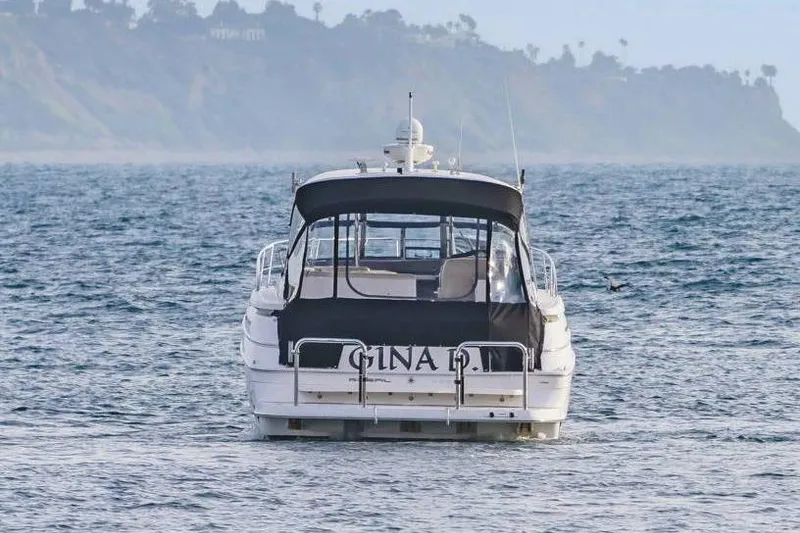 Slide: The Image of 2010 Regal Commodore 4460 yacht on ocean with distant coastline. - 8