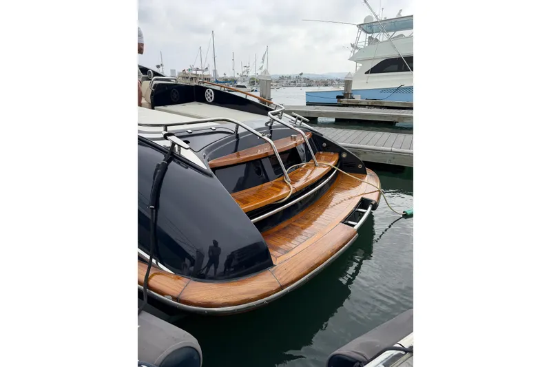 Slide: The Image of Luxurious 2012 Riva 44' Rivarama yacht docked at marina, showcasing elegant wooden deck. - 11