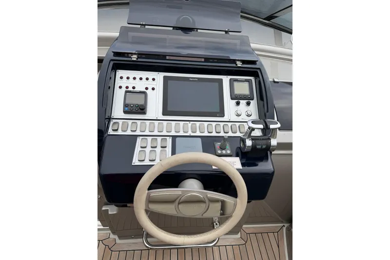 Slide: The Image of Control panel of 2012 Riva 44' Rivarama yacht with steering wheel and navigation instruments. - 13