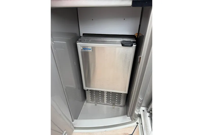 Slide: The Image of Compact refrigerator inside 2012 Riva 44' Rivarama yacht, featuring sleek stainless steel design. - 16