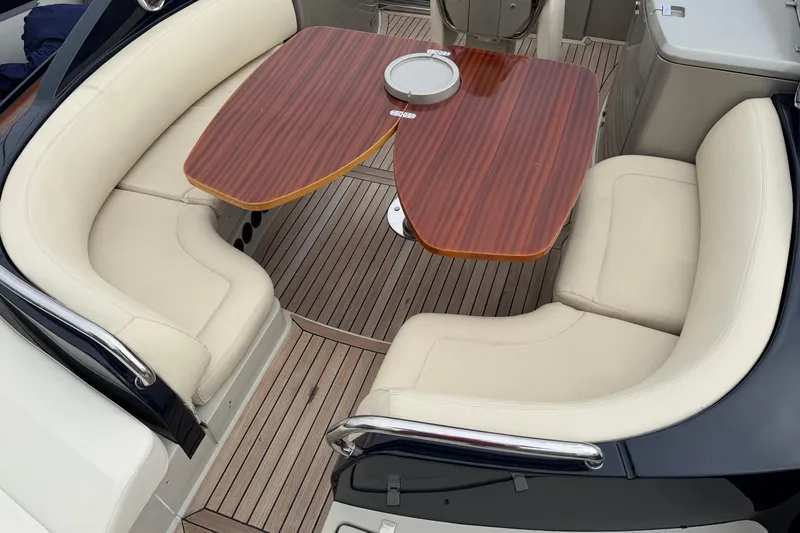 Slide: The Image of Luxurious seating area on 2012 Riva 44' Rivarama yacht with elegant wooden table. - 18