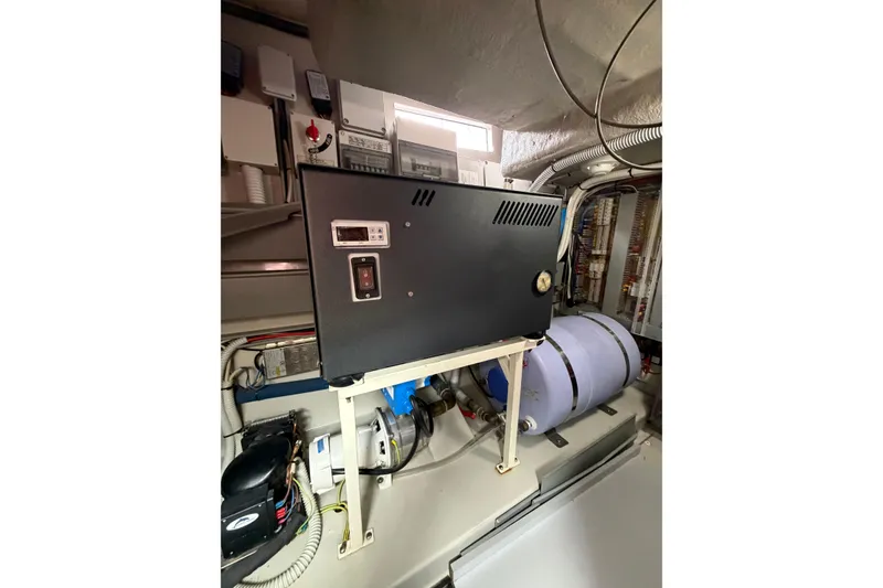 Slide: The Image of Engine room of 2012 Riva 44' Rivarama yacht, showcasing electrical equipment and components. - 27