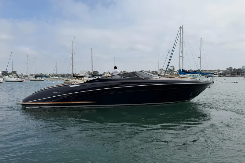 Slide: The Image of 2012 Riva 44' Rivarama luxury yacht cruising in a marina with sailboats. - 7