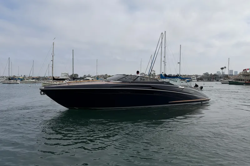 Slide: The Image of Luxurious 2012 Riva 44' Rivarama yacht cruising in a marina with sailboats. - 8