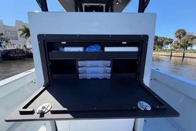 Slide: The Image of Storage compartment on a 2026 Orion 29 boat, featuring organized shelves and containers. - 10