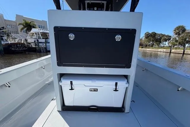 Slide: The Image of Orion 29 boat interior with Yeti cooler, docked by waterfront, 2026 model. - 11