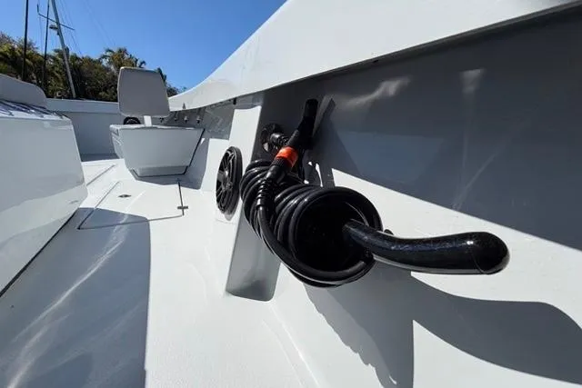 Slide: The Image of Orion 29 boat deck with coiled hose, 2026 model, under clear blue sky. - 13