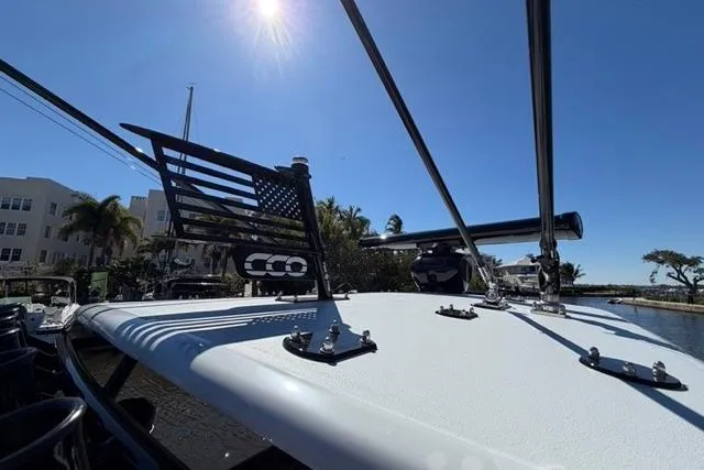 Slide: The Image of A 2026 Orion 29 boat deck under clear blue sky with sunlight. - 17