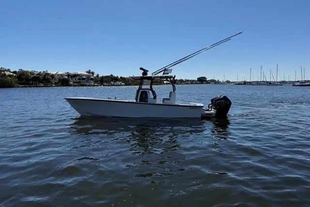 Slide: The Image of A 2026 Orion 29 boat on calm water with fishing rods and distant shoreline. - 20