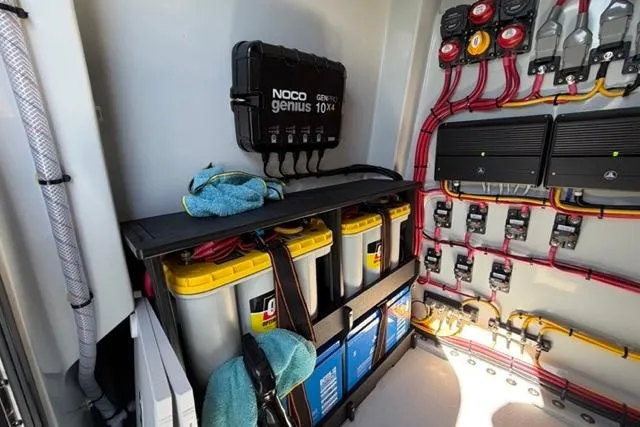 Slide: The Image of Electrical system setup in Orion 29 model, featuring batteries and NOCO Genius charger. - 26