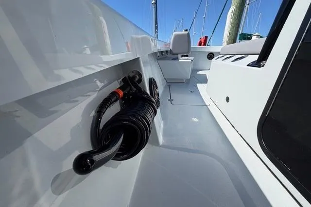 Slide: The Image of 2026 Orion 29 boat deck with coiled black hose and sleek white finish. - 27