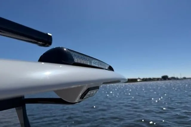 Slide: The Image of Sleek Orion 29 boat detail against a clear blue sky and water, 2026 model. - 29