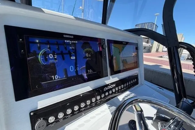 Slide: The Image of Dashboard of 2026 Orion 29 boat with navigation screens and controls. - 31
