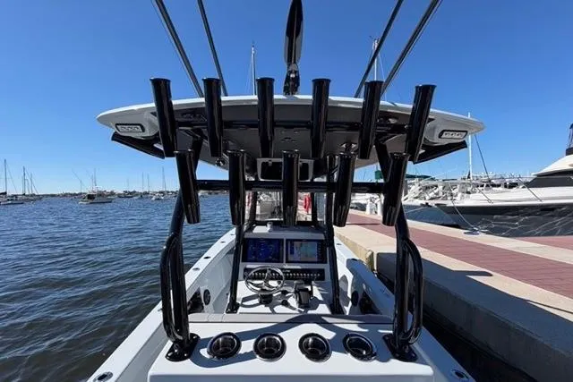 Slide: The Image of Cockpit view of 2026 Orion 29 boat docked at marina with clear blue sky. - 32