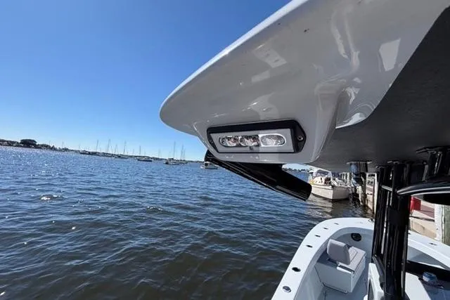 Slide: The Image of 2026 Orion 29 boat with LED lights, docked by a marina under clear blue sky. - 33