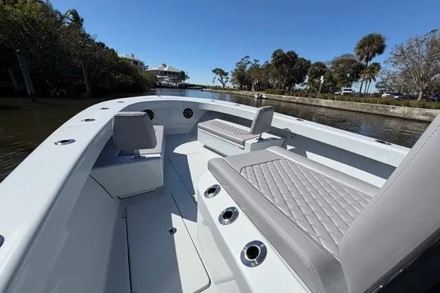 Slide: The Image of 2026 Orion 29 boat with sleek seating, cruising on a scenic waterway. - 6