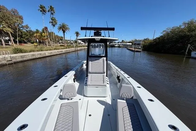 Slide: The Image of 2026 Orion 29 boat on a calm river, surrounded by lush greenery and palm trees. - 7