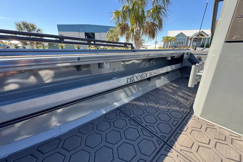 Slide: The Image of Prodigy 1960 Marsh Tuff boat, 2024 model, with sleek design and textured flooring. - 11