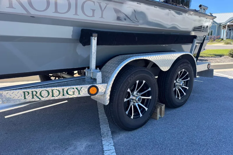 Slide: The Image of Trailer of 2024 Prodigy 1960 Marsh Tuff boat with dual wheels and metallic finish. - 16
