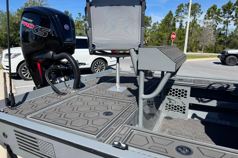 Slide: The Image of 2024 Prodigy 1960 Marsh Tuff boat with Mercury Pro XS engine, parked outdoors. - 6