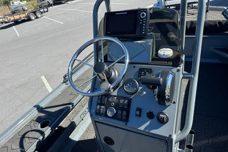 Slide: The Image of Control panel of 2024 Prodigy 1960 Marsh Tuff boat with steering wheel and gauges. - 9